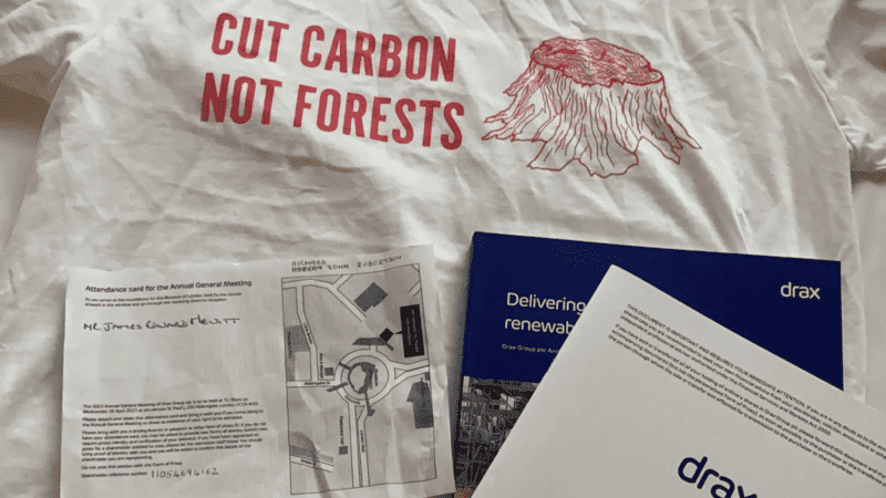 Drax AGM badge and shirt that reads "cut carbon not forests"