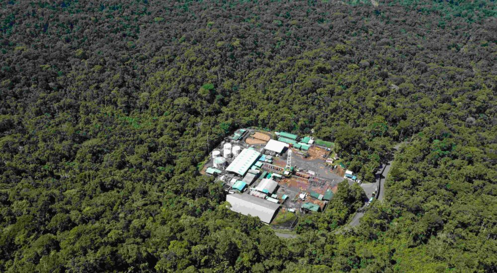 Drone view of the Amazon rainforest with an oil drilling station in the middle