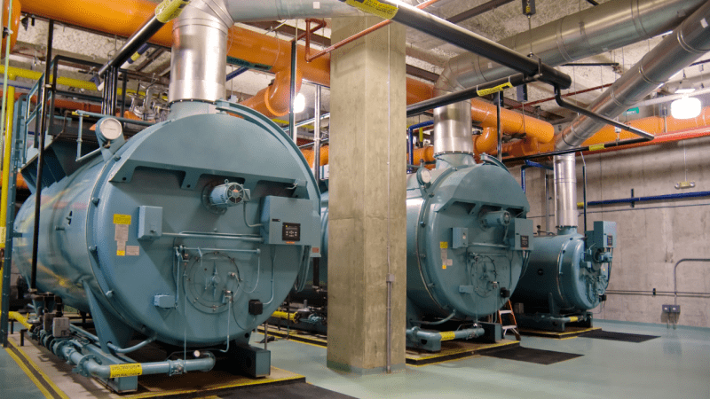 two industrial boilers in a factory setting