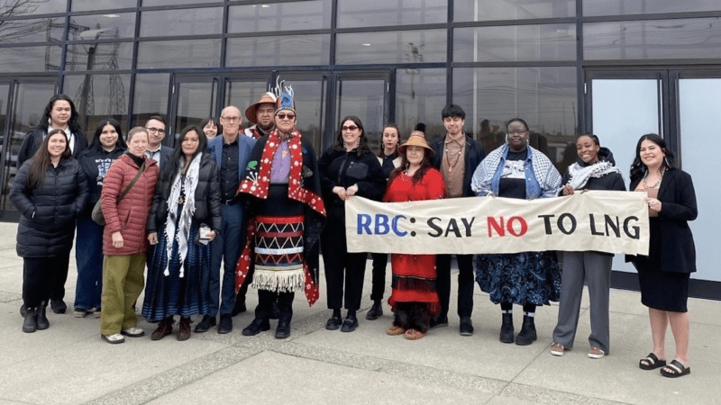 group of Indigenous leaders & climate advocates outside the RBC 2025 shareholder meeting with a banner reading "RBC: Say no to LNG"