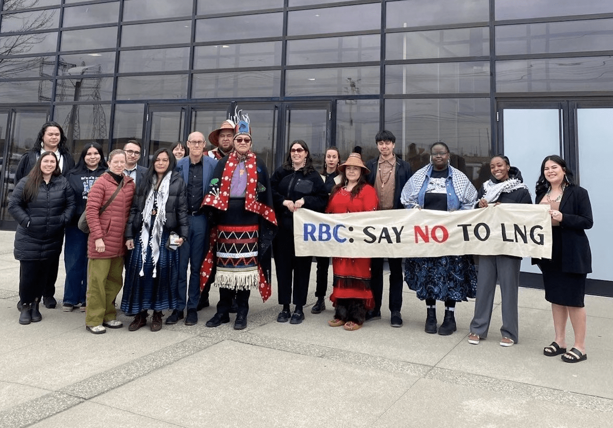 group of Indigenous leaders & climate advocates outside the RBC 2025 shareholder meeting with a banner reading "RBC: Say no to LNG"